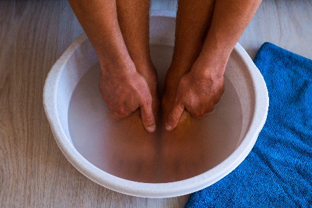 Man-with-feet-soaking-for-at-home-pedicure