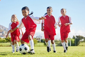 child running with proper shoes to prevent sports injuries