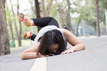 Woman falling while walking outdoors showing fall risk