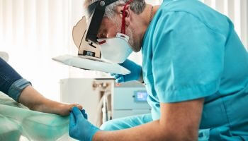 Podiatrist examining a patient's foot for healthy feet