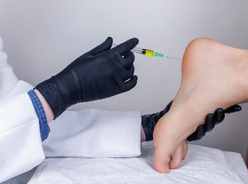 Podiatrist administering PRP injection to the foot