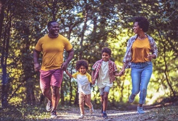 Family walking outdoors in supportive shoes during summer